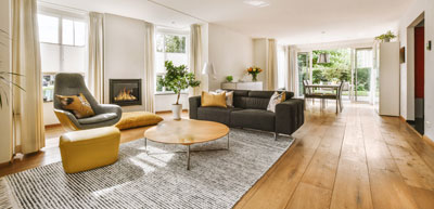 A living room with wooden floors and a fire place